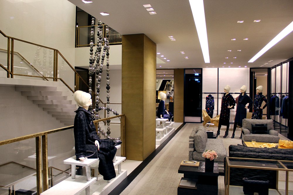 A Chanel retail store with large supporting pillars covered in textured bronze.